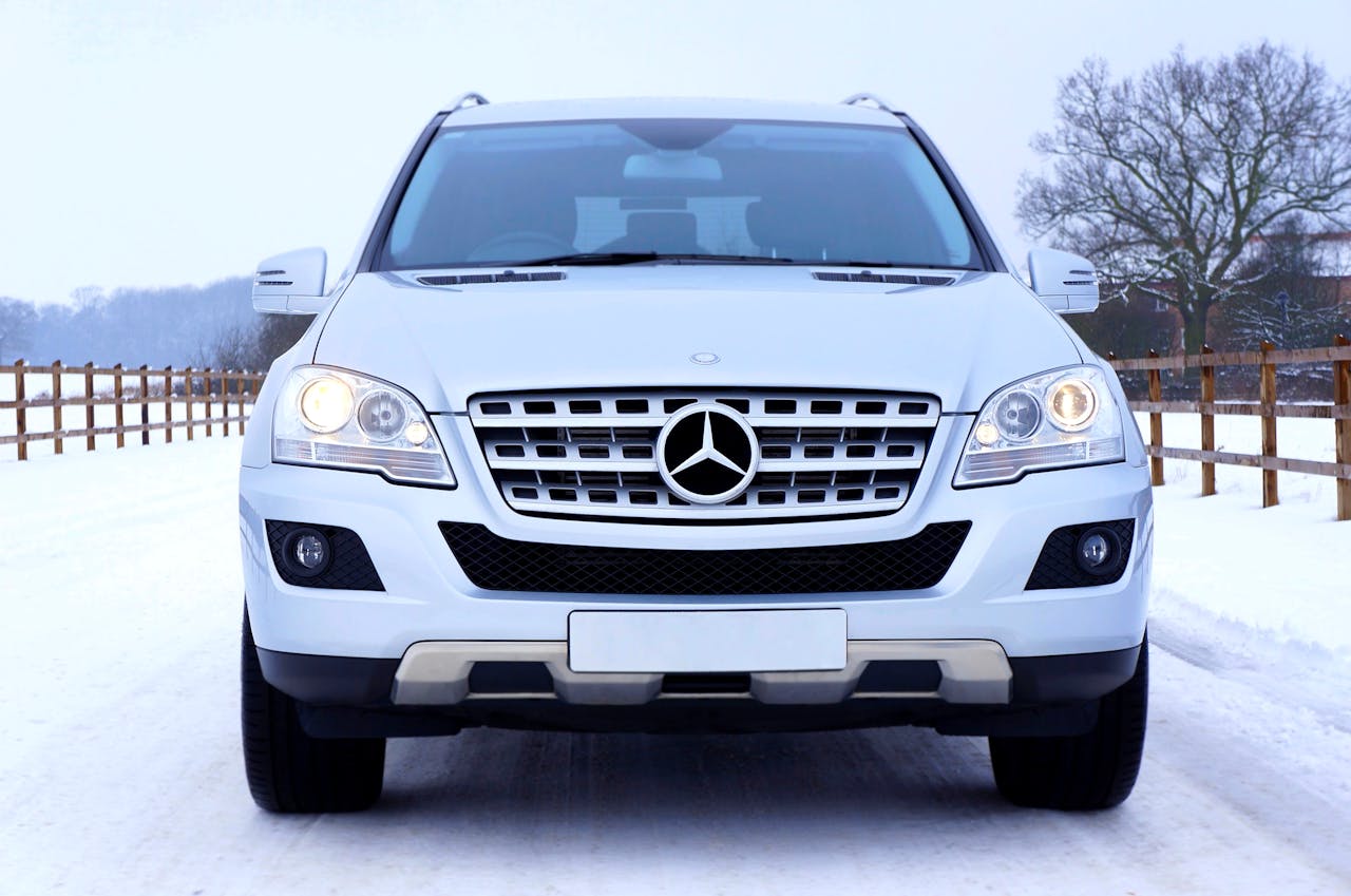 Front view of a Mercedes-Benz SUV on a snowy road in Dumfries and Galloway, Scotland.